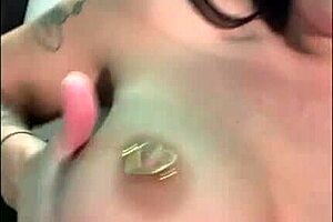 the mature brunette with big tits and tattoos shows off her piercings