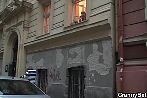 A mature woman is having sex with a younger man on the couch
