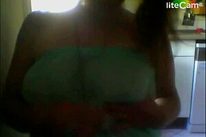 A milf with big tits showcases her assets in a steamy scene