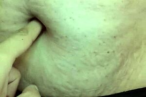 A sexy MILF is showing her belly button to the camera