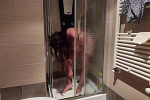 Horny mature woman with big boobs shaves her pussy in the shower