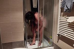Horny mature woman with big boobs shaves her pussy in the shower