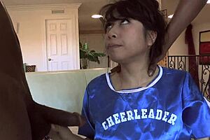 Look at this Asian babe sucking two huge black cocks like a pro!