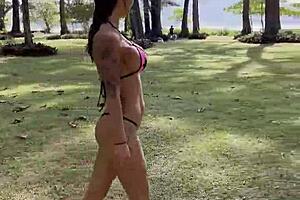 monika fox poses beautifully in a pink bikini on the beach