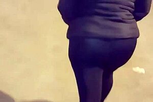 Look at this mature street whore flashing her thong in transparent leggings outdoors.