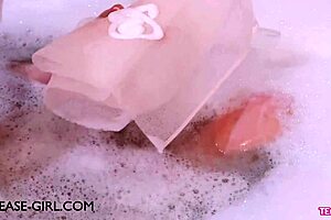 Enchanting brunette muse relaxes in a sensual bath on the sofa