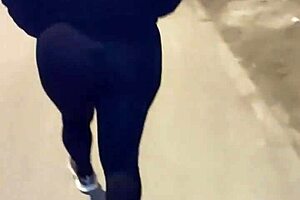 Look at this mature street whore flashing her thong in transparent leggings outdoors.