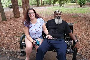 Nerdy milf strokes and sucks big black dick in the park