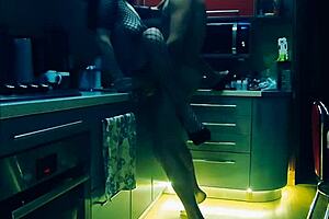 beautiful slender wife in erotic bodysuit in the kitchen