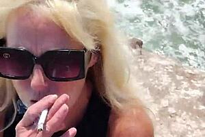 A milf goes nude in public outdoor setting