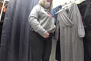 a plump milf with juicy ass in white panties and big tits in bra caught on hidden camera in public dressing room