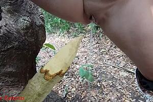hey check it, this perverted slut is squirting piss from a wooden stake deep in the forest outdoors 😈🌳💦