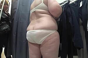 a plump milf with juicy ass in white panties and big tits in bra caught on hidden camera in public dressing room