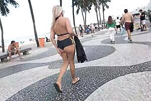 Walking in mini short along Copacabana beach drawing looks from men
