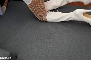 perfect-assed milf struts in high-heeled boots and fishnet stockings, showing off her curves