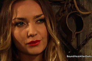 Busty lesbian slave with big tits bound tightly and branded harshly by her dominant mistress in intense bondage session