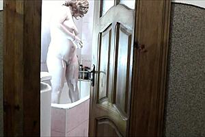 naked sexy blonde woman in bathroom without panties. Pervert man roommate watches outside masturbating cock for cumshot on old young 18+ wet pussy with natural tits.
