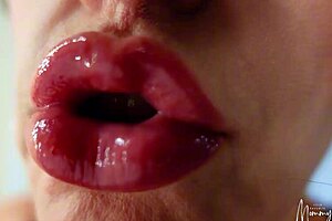 Sexy brunette milf gives oral fetish dildo blowjob with bimbo lips in close up solo session. She licks the lollipop toy softly on bed.