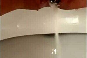 close up on shaved pussy lips pierced clit squirting wet in public toilet outdoors