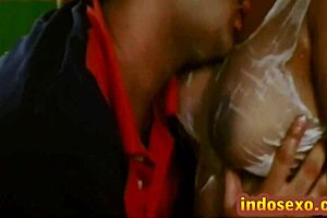 Young guy licks honey off Indian mature woman's big boobs