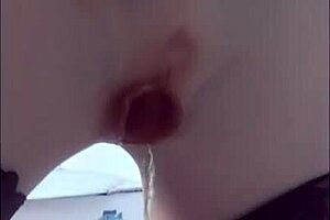 She strips outdoors peels off silicone skin and strokes pussy close-up in stockings