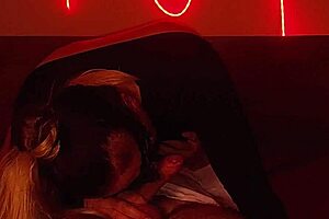 blonde milf sucks cock then rides it hard under red lights