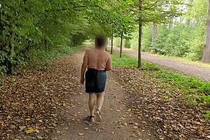 A busty milf goes topless outdoors flashing her curves