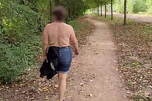 A busty milf goes topless outdoors flashing her curves